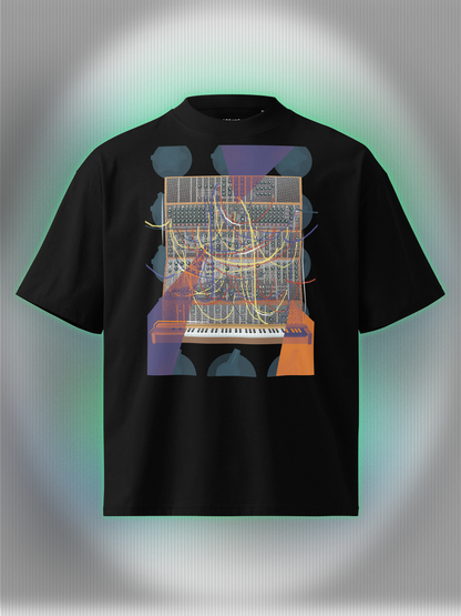 Black T-shirt with a vibrant graphic design of a modular synthesizer with patch cables and knobs on the background with orange and purple geometric colorful elements.