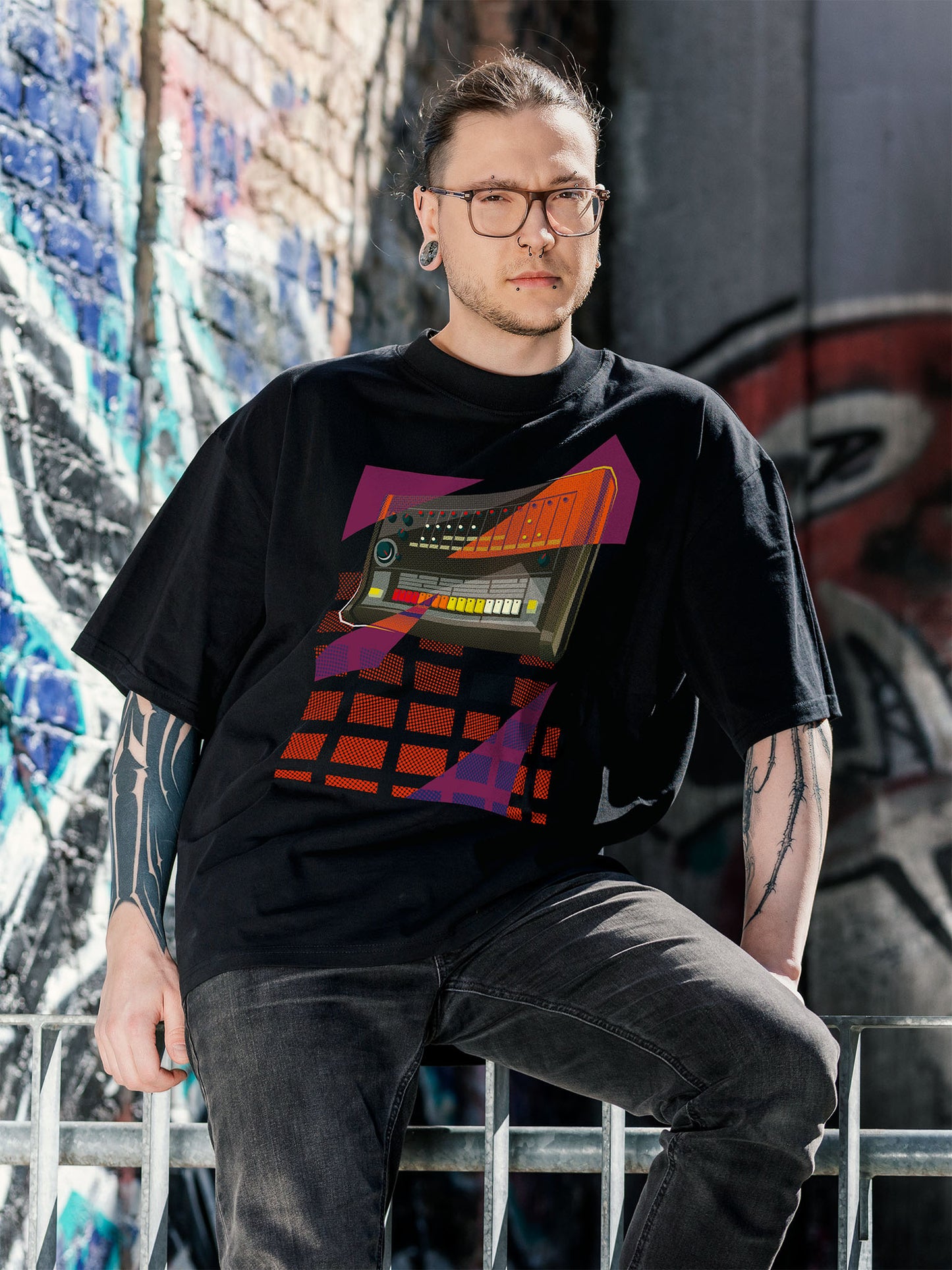 Black T-shirt with a graphic design of a drum machine 808 with purple and orange geometric colorful elements.