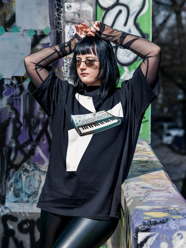 Black T-shirt with a design of a synthesizer and white geometrical light beams go out of the synth.