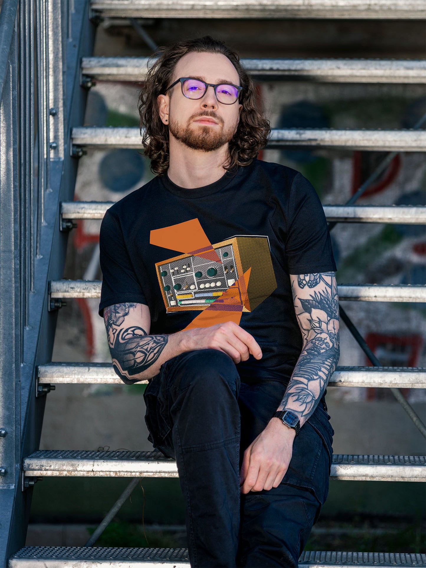 Black T-shirt with a retro graphic design of a colorful drum machine 78 with orange geometric colorful elements.