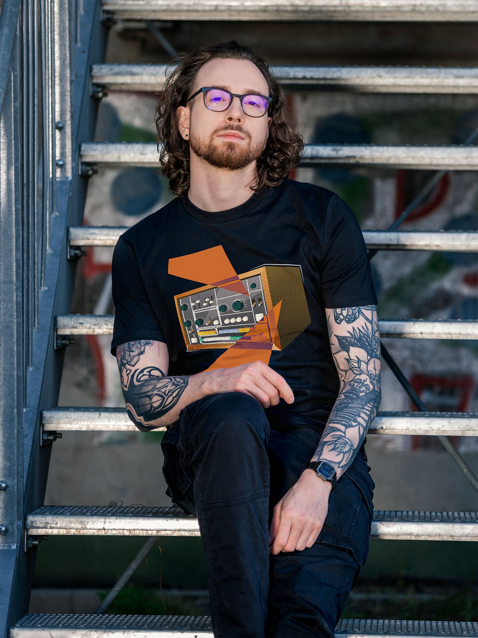 Black T-shirt with a retro graphic design of a colorful drum machine 78 with orange geometric colorful elements.