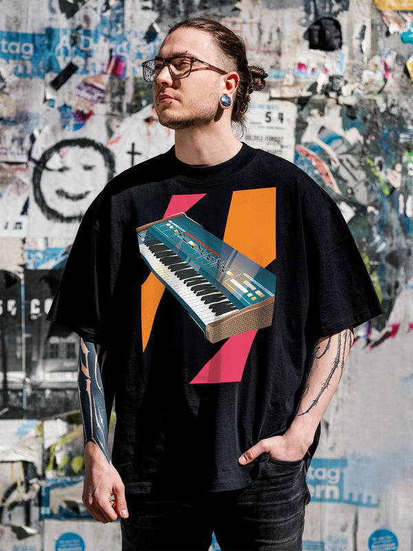 Black T-shirt with a graphic design of a colorful synthesizer with pink and orange geometric colorful elements.