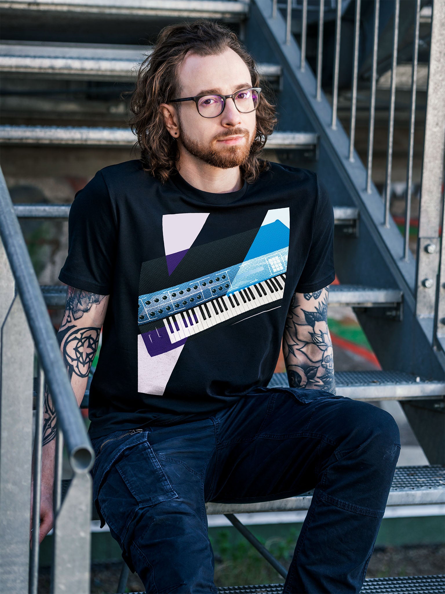 Black T-shirt with a graphic design of a colorful synthesizer with white and purple geometric colorful elements.